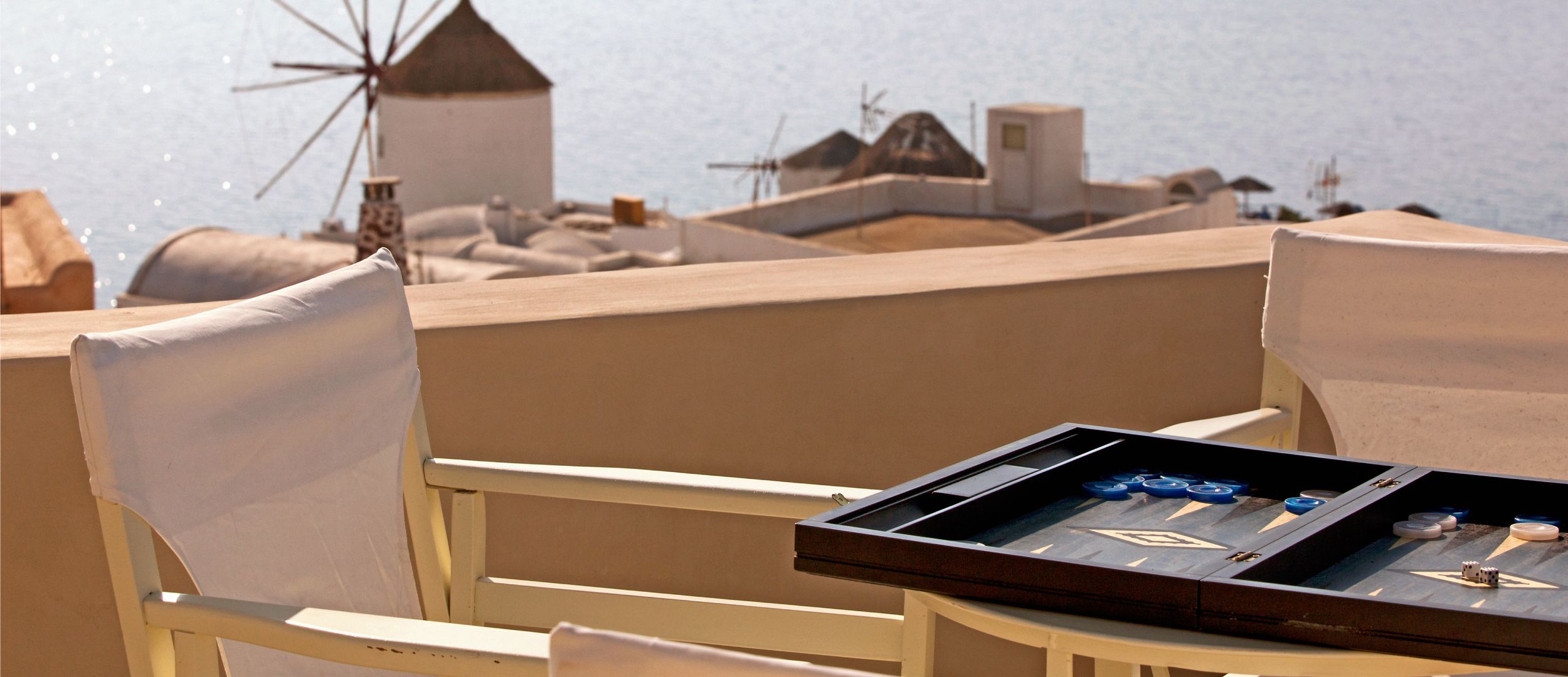 Relaxing on the Balcony enjoying the Amazing View - Oia Mansion - Luxurious 4 Bedroom Mansion Rental in Santorini